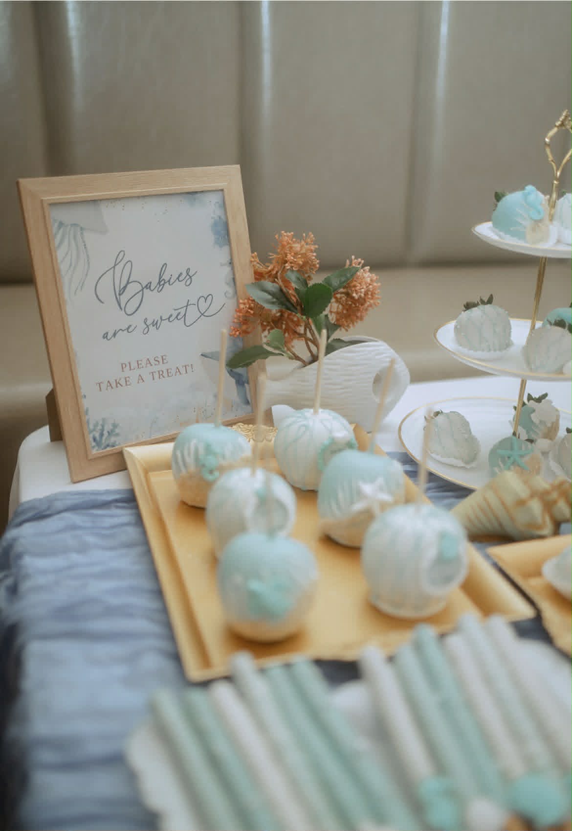 Ocean themed baby shower sweets table with cake pops