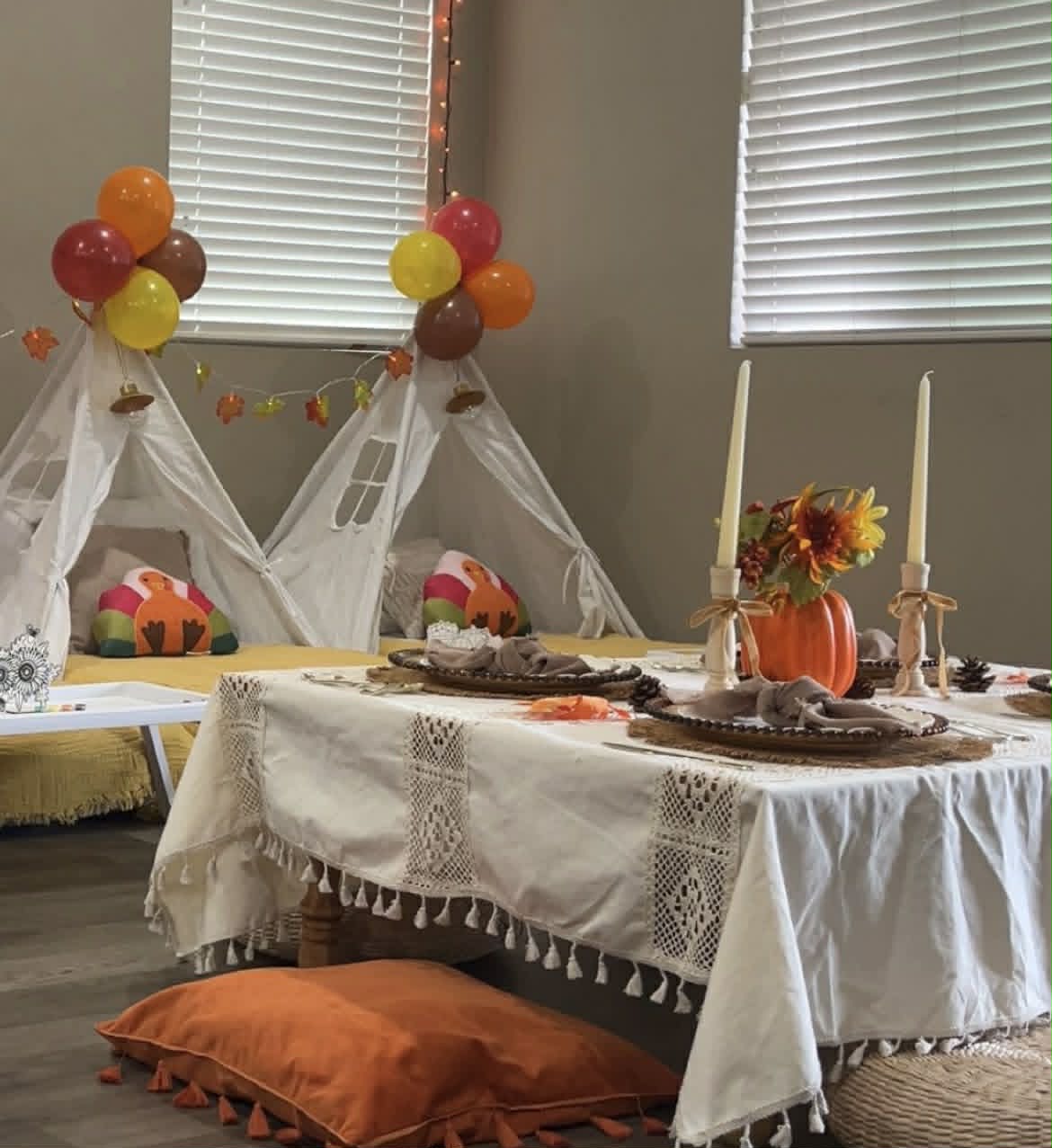 Fall harvest teepee party with pumpkin and sunflower centerpiece
