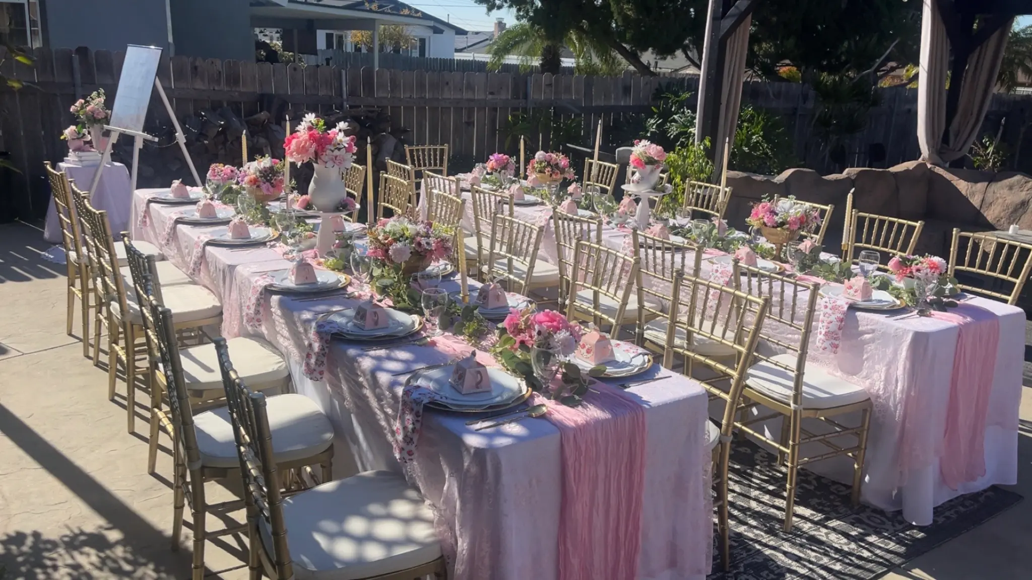 Elegant pink outdoor tablescape with gold chiavari chairs