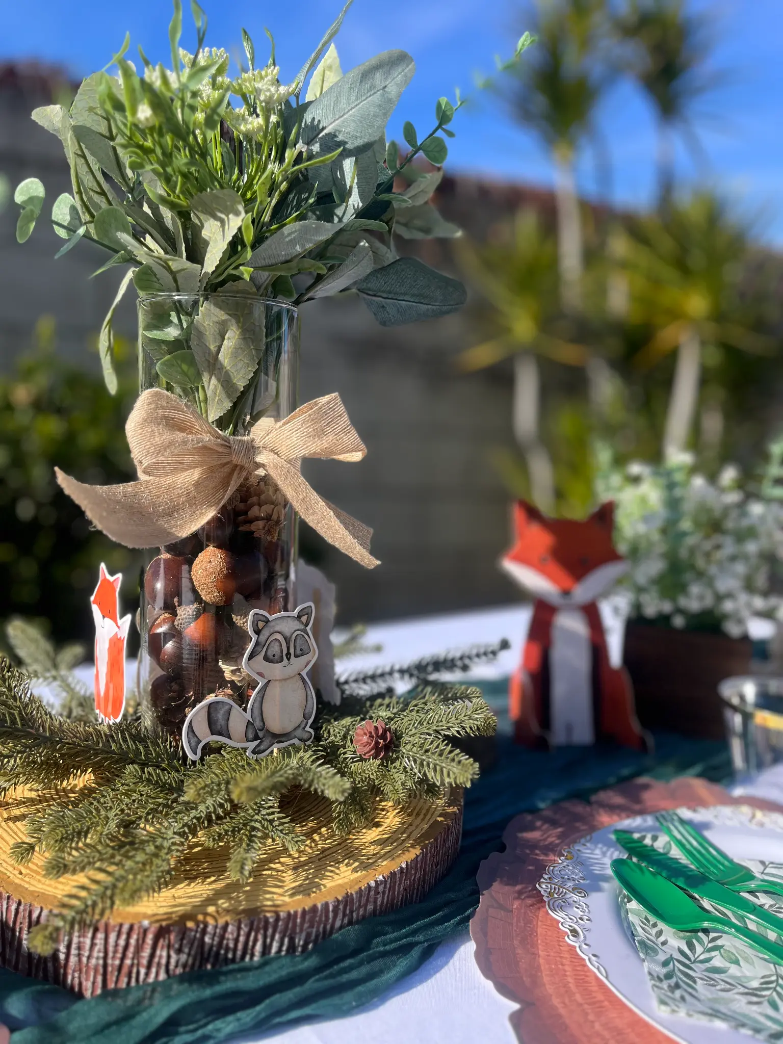 Woodland themed tablescape with fox and raccoon decorations