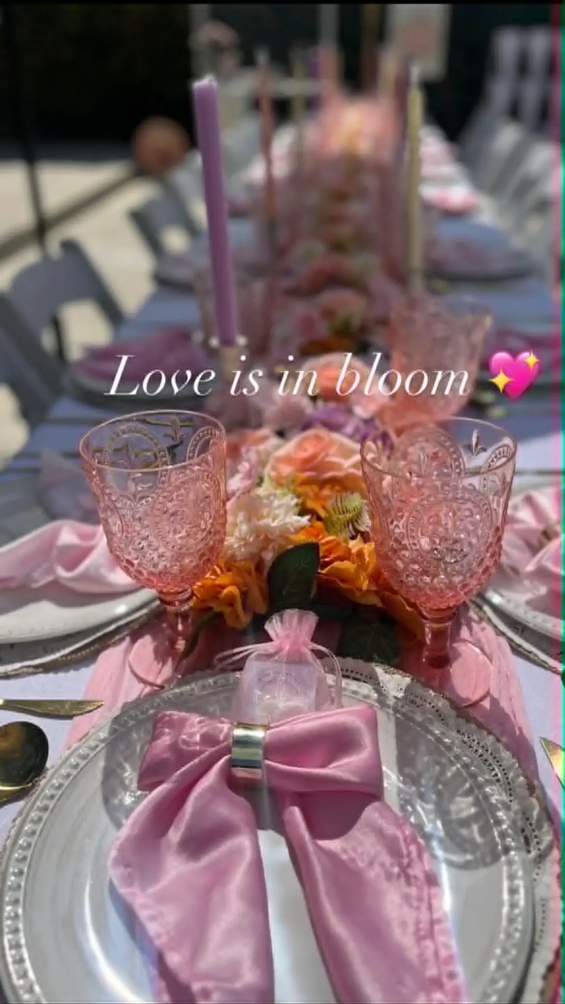 Love is in bloom pink outdoor tablescape with crystal glasses